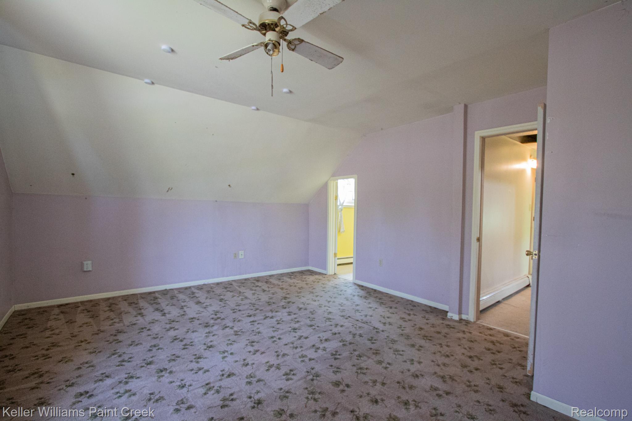 2165 Michigan Road Port Huron, MI 48060 - Photo 28 of 38 Additional living space featuring light carpet, ceiling fan, and vaulted ceiling
