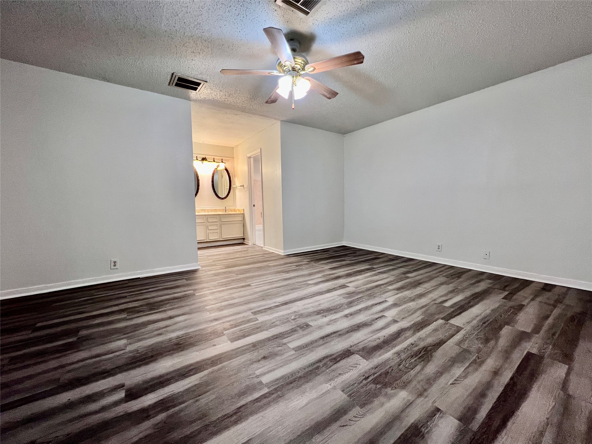 23111 Bayleaf Drive Spring, TX 77373 - Photo 11 of 28 a view of an empty room with wooden floor and a ceiling fan