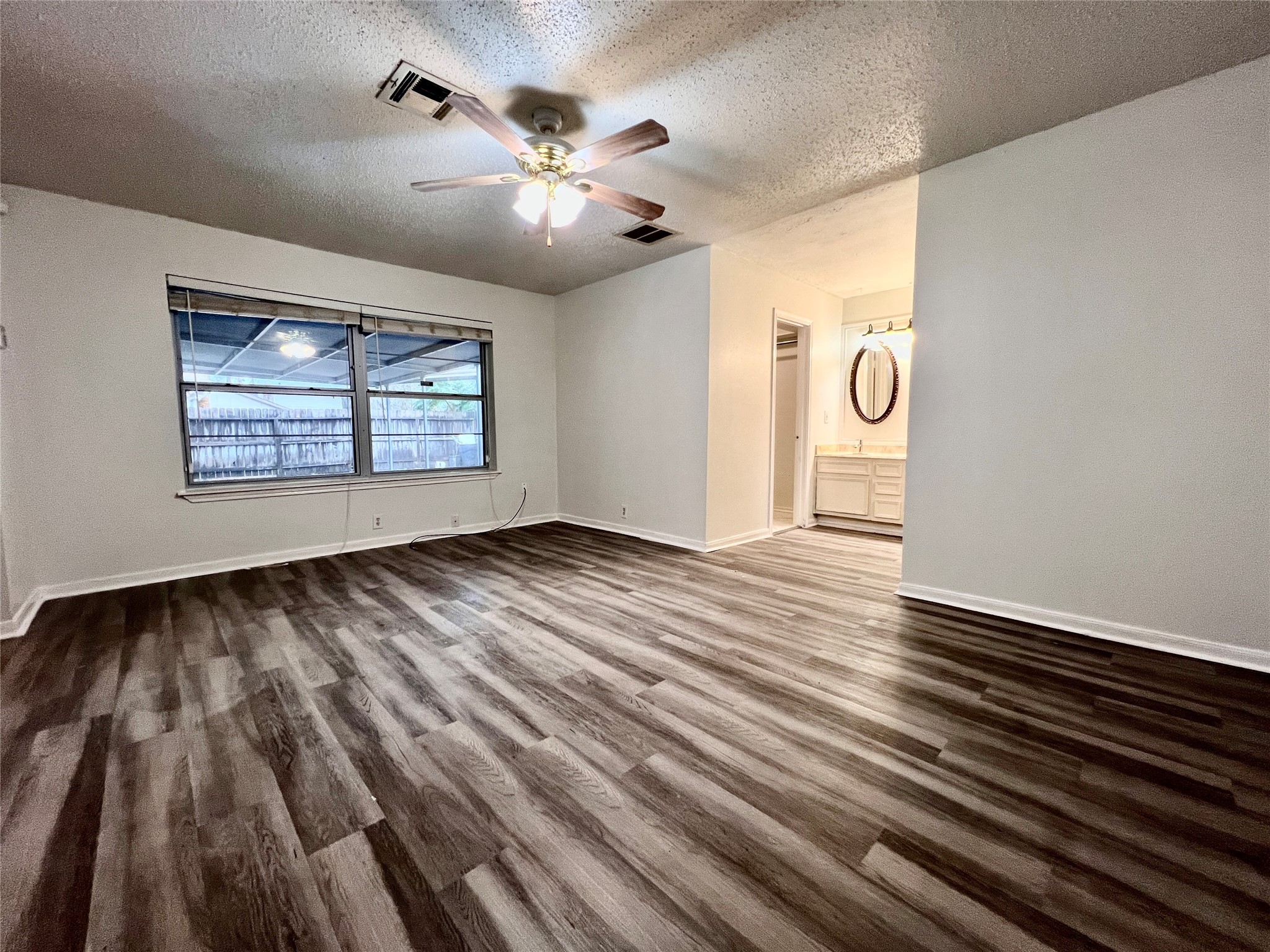 23111 Bayleaf Drive Spring, TX 77373 - Photo 12 of 28 wooden floor in an empty room with a window