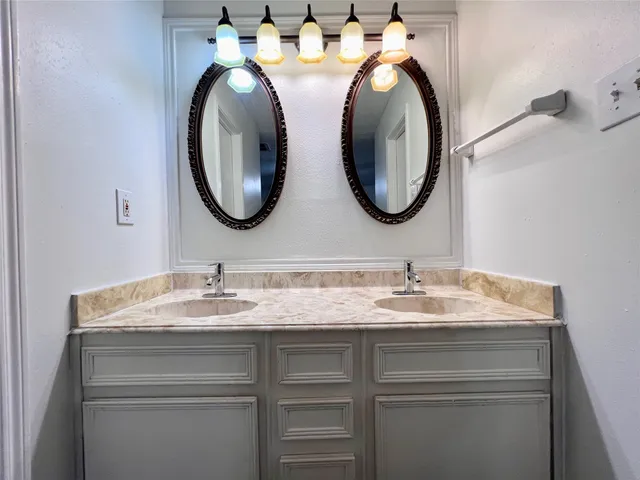 a bathroom with 2 sink and a mirror