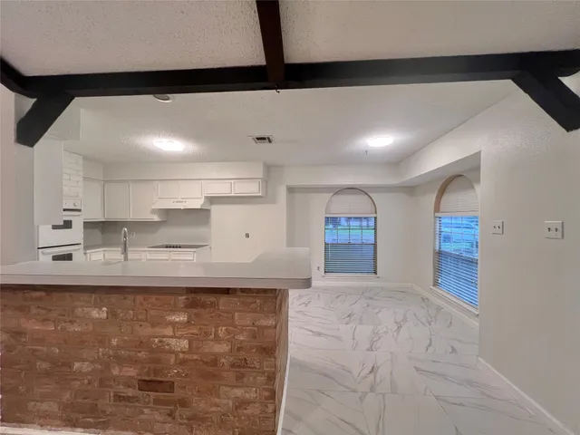 a large kitchen with kitchen island a sink stainless steel appliances and cabinets