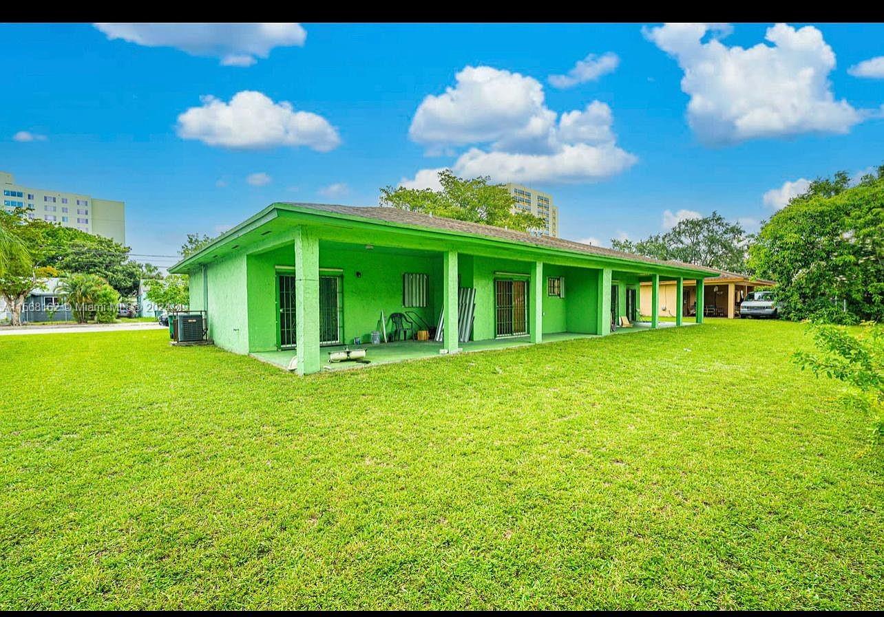 2320 Northwest 52nd Street, Unit A Miami, FL 33142 - Photo 2 of 8 a view of a house with a backyard