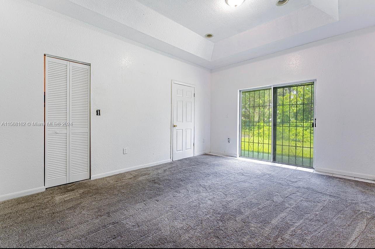 2320 Northwest 52nd Street, Unit A Miami, FL 33142 - Photo 7 of 8 a view of an empty room with a window