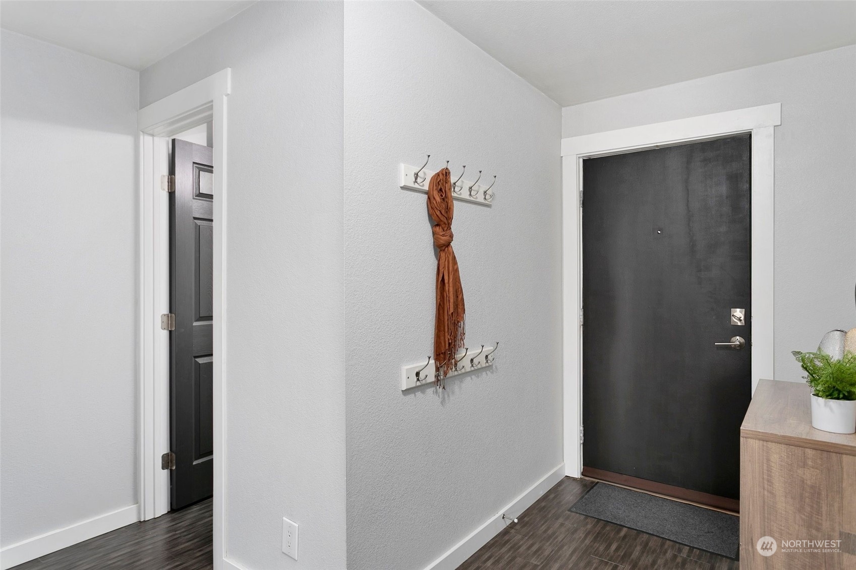 1425 South Puget Drive, Unit 308 Renton, WA 98055 - Photo 13 of 23 a view of a hallway with wooden floor and door