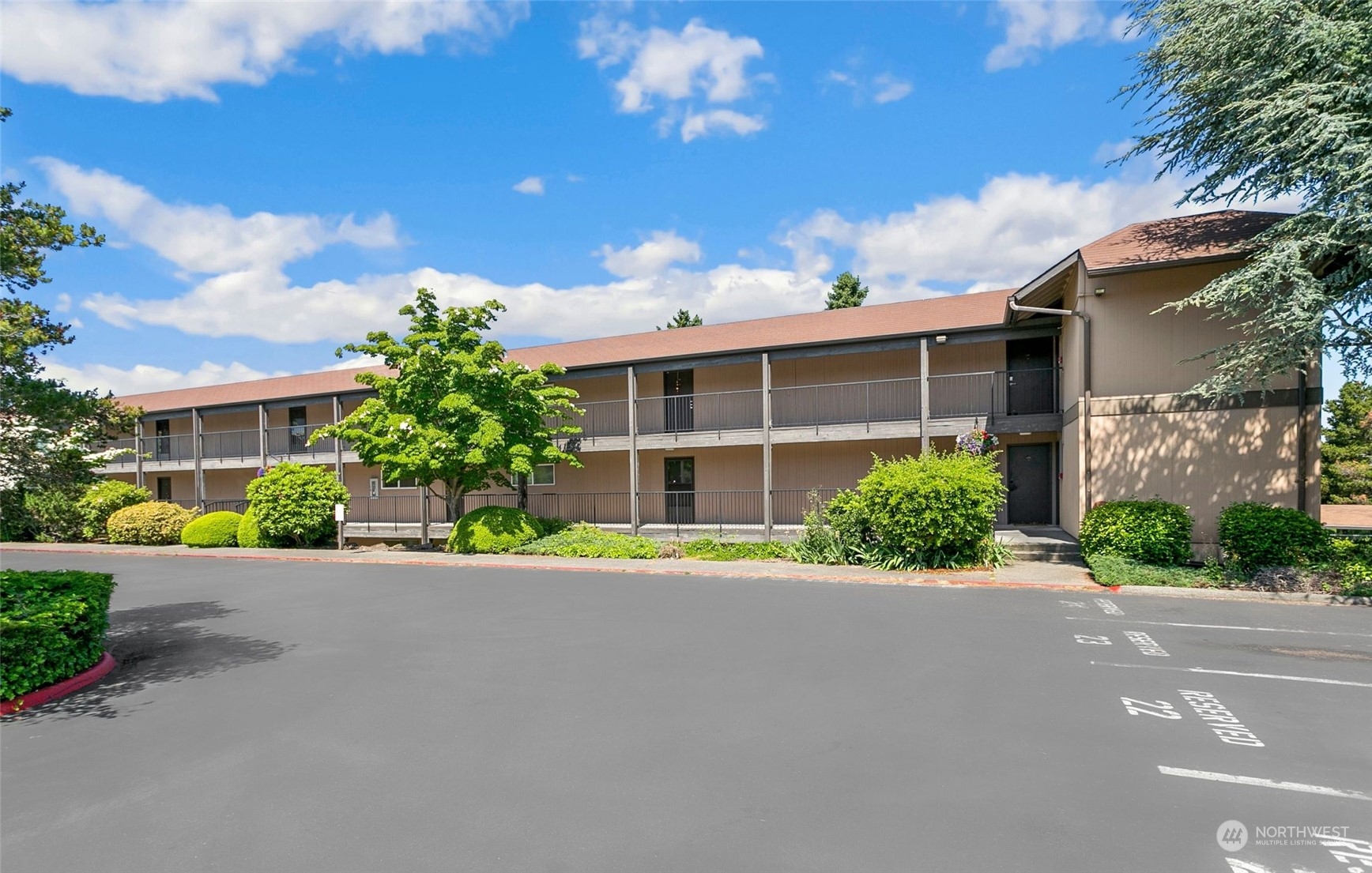 1425 South Puget Drive, Unit 308 Renton, WA 98055 - Photo 17 of 23 a front view of a house with a yard and a garage