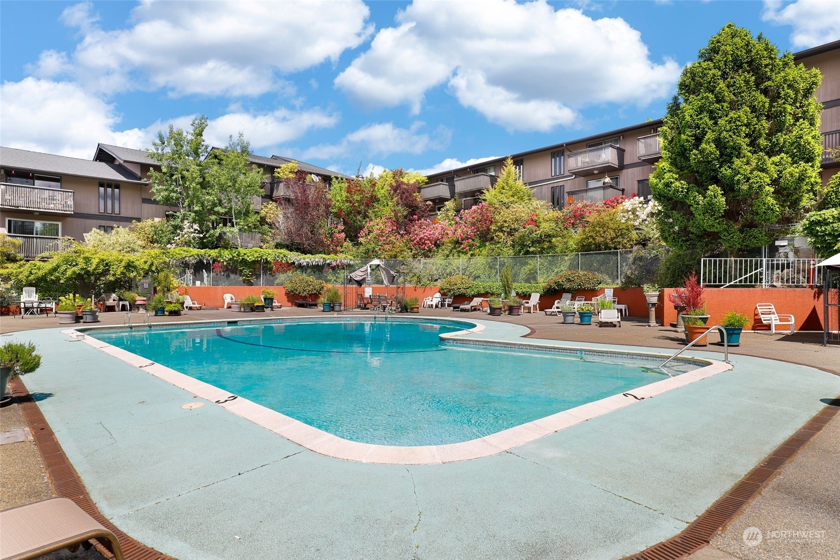 1425 South Puget Drive, Unit 308 Renton, WA 98055 - Photo 20 of 23 a view of a swimming pool with a patio