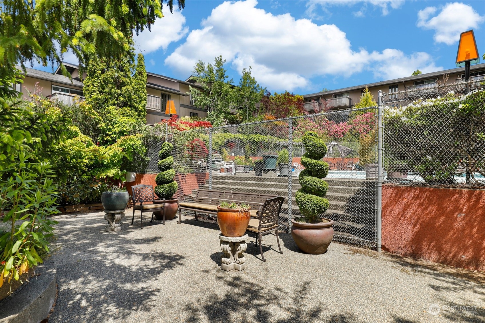 1425 South Puget Drive, Unit 308 Renton, WA 98055 - Photo 22 of 23 a backyard of a house with barbeque oven table and chairs