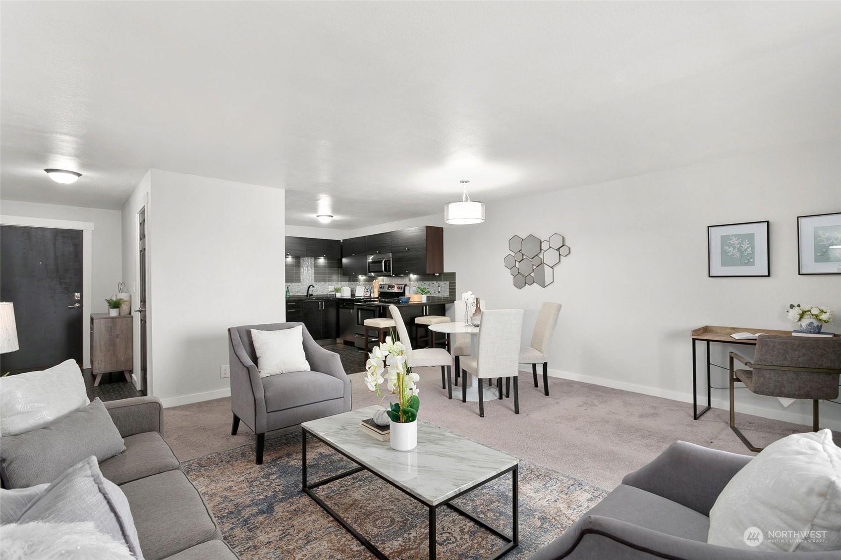 1425 South Puget Drive, Unit 308 Renton, WA 98055 - Photo 3 of 23 a living room with lots of furniture and view of kitchen