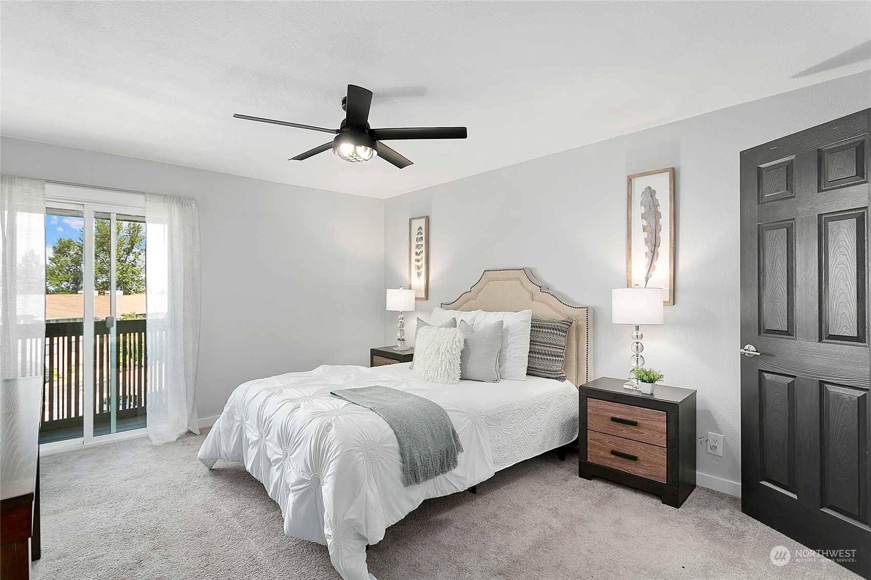 1425 South Puget Drive, Unit 308 Renton, WA 98055 - Photo 8 of 23 a bedroom with a large bed and a chandelier