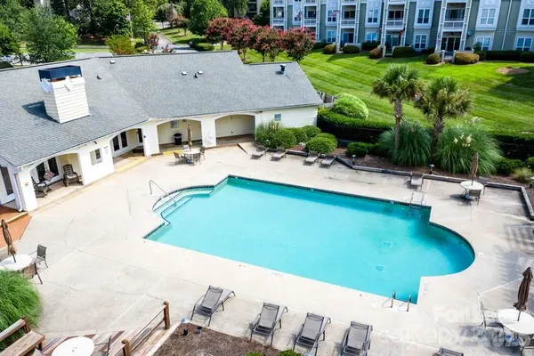 swimming pool view with a seating space