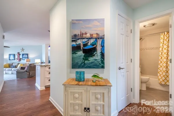 a view of living room with furniture and wooden floor