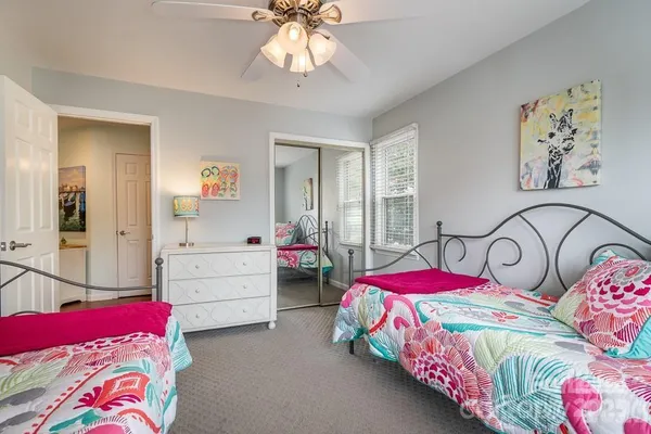 a bedroom with two beds and a chandelier