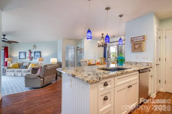 a kitchen with kitchen island granite countertop counter top space and a sink