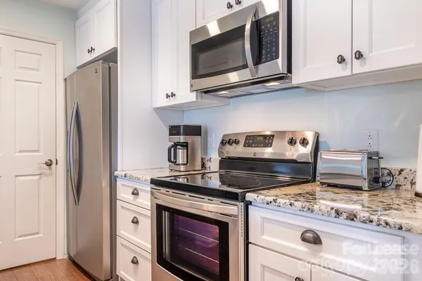 a stove top oven sitting inside of a kitchen