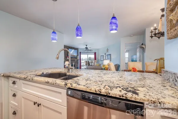 a kitchen view of a stove and a sink