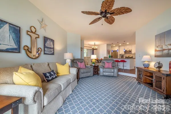 a living room with furniture and a chandelier