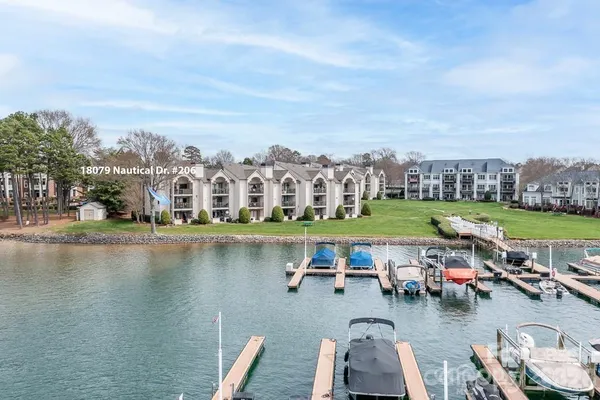 an aerial view of a city with lots of residential buildings lake and ocean view