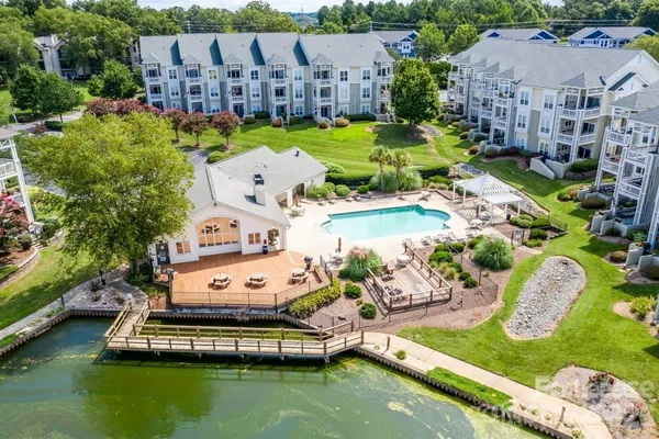 an aerial view of a house with yard swimming pool and outdoor seating