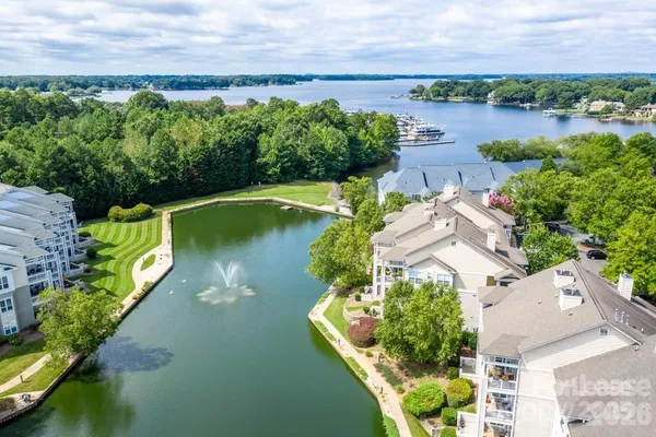 an aerial view of a house with a yard lake house and outdoor seating