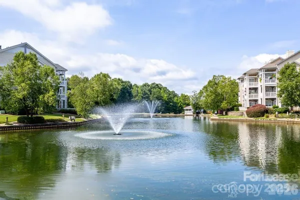a view of a lake with houses in the back