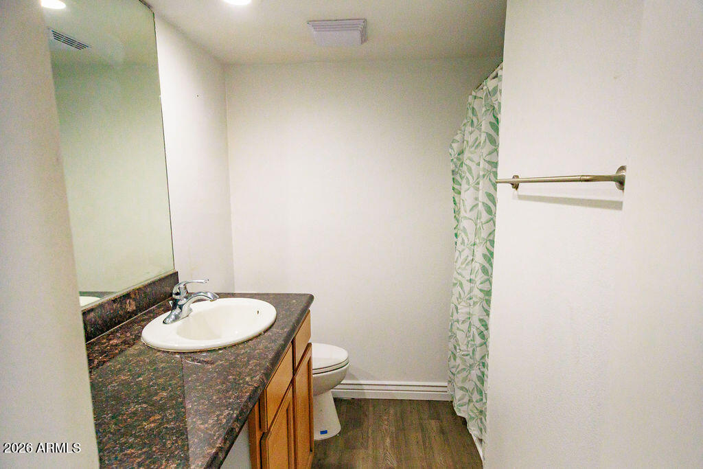 1702 West Tuckey Lane, Unit 103 Phoenix, AZ 85015 - Photo 11 of 13 a bathroom with a sink and a mirror