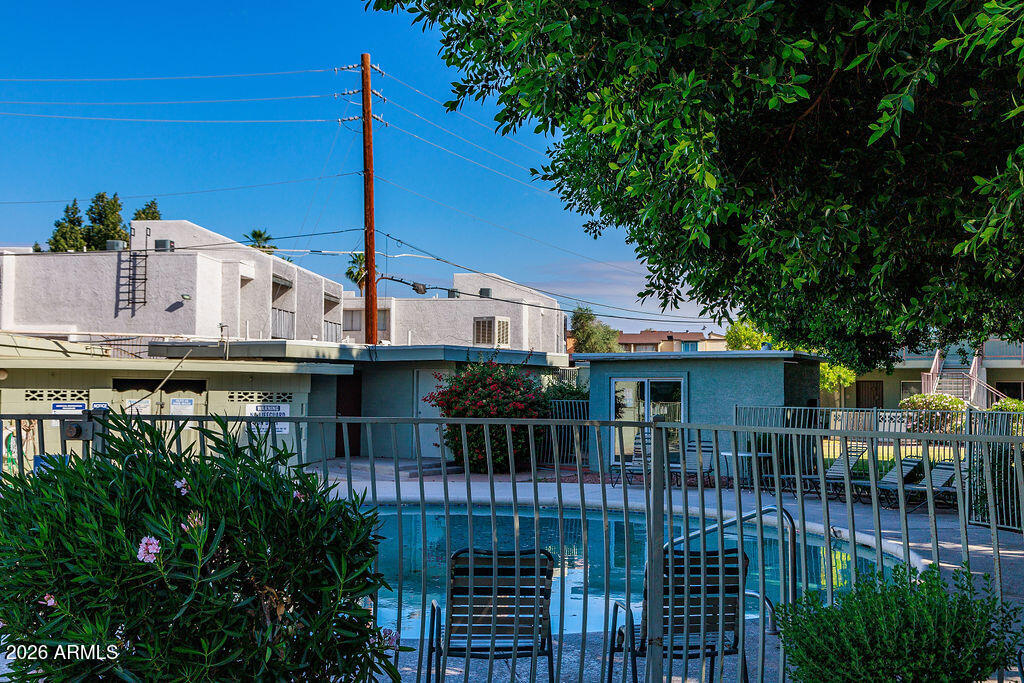 1702 West Tuckey Lane, Unit 103 Phoenix, AZ 85015 - Photo 3 of 13 a balcony with tall trees in front of it