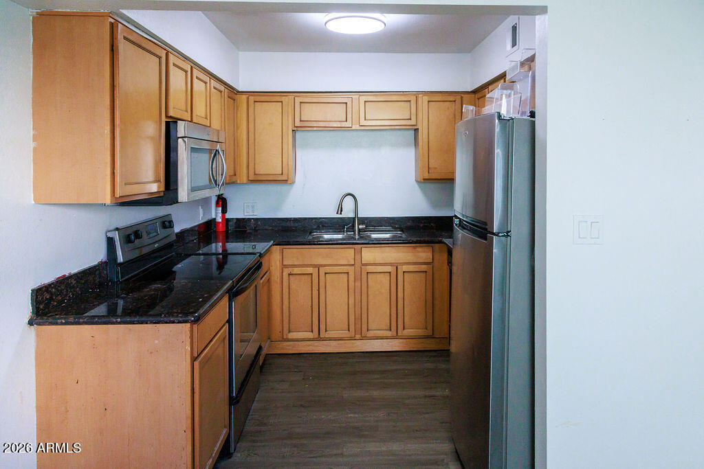 1702 West Tuckey Lane, Unit 103 Phoenix, AZ 85015 - Photo 8 of 13 a kitchen with a sink and a stove