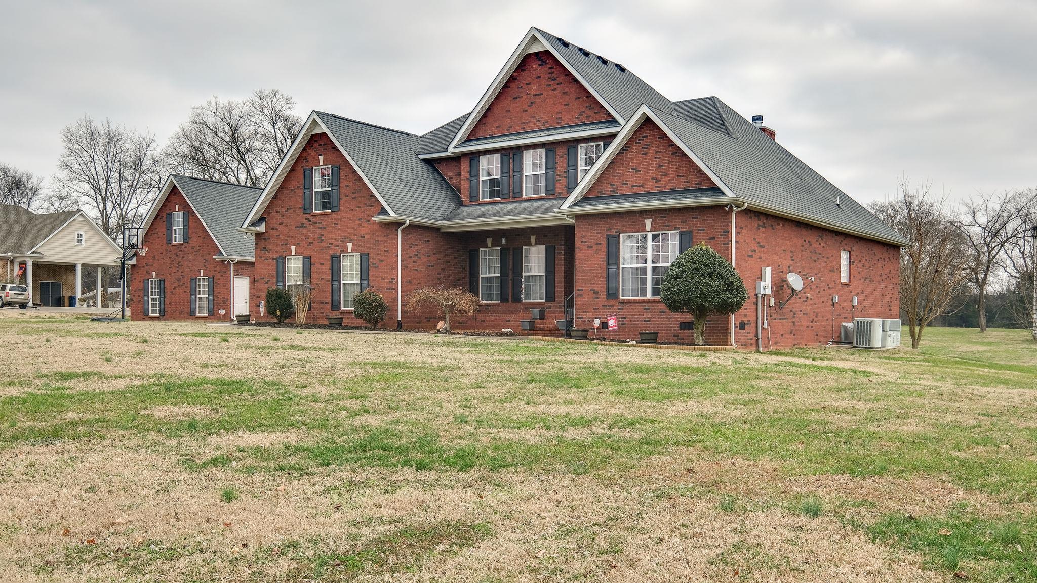 7920 Powells Chapel Road Murfreesboro, TN 37129 - Photo 1 of 29 a front view of a house with a yard and trees