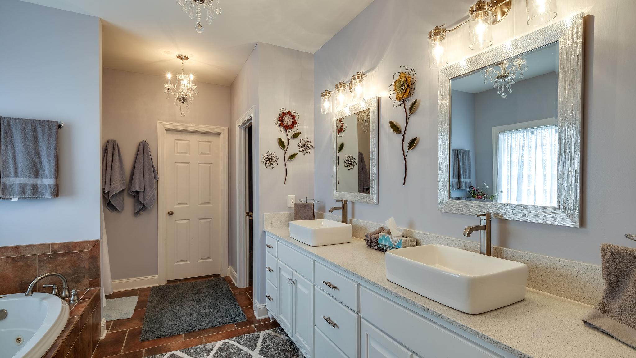 7920 Powells Chapel Road Murfreesboro, TN 37129 - Photo 12 of 29 a bathroom with a double vanity sink a mirror and a shower