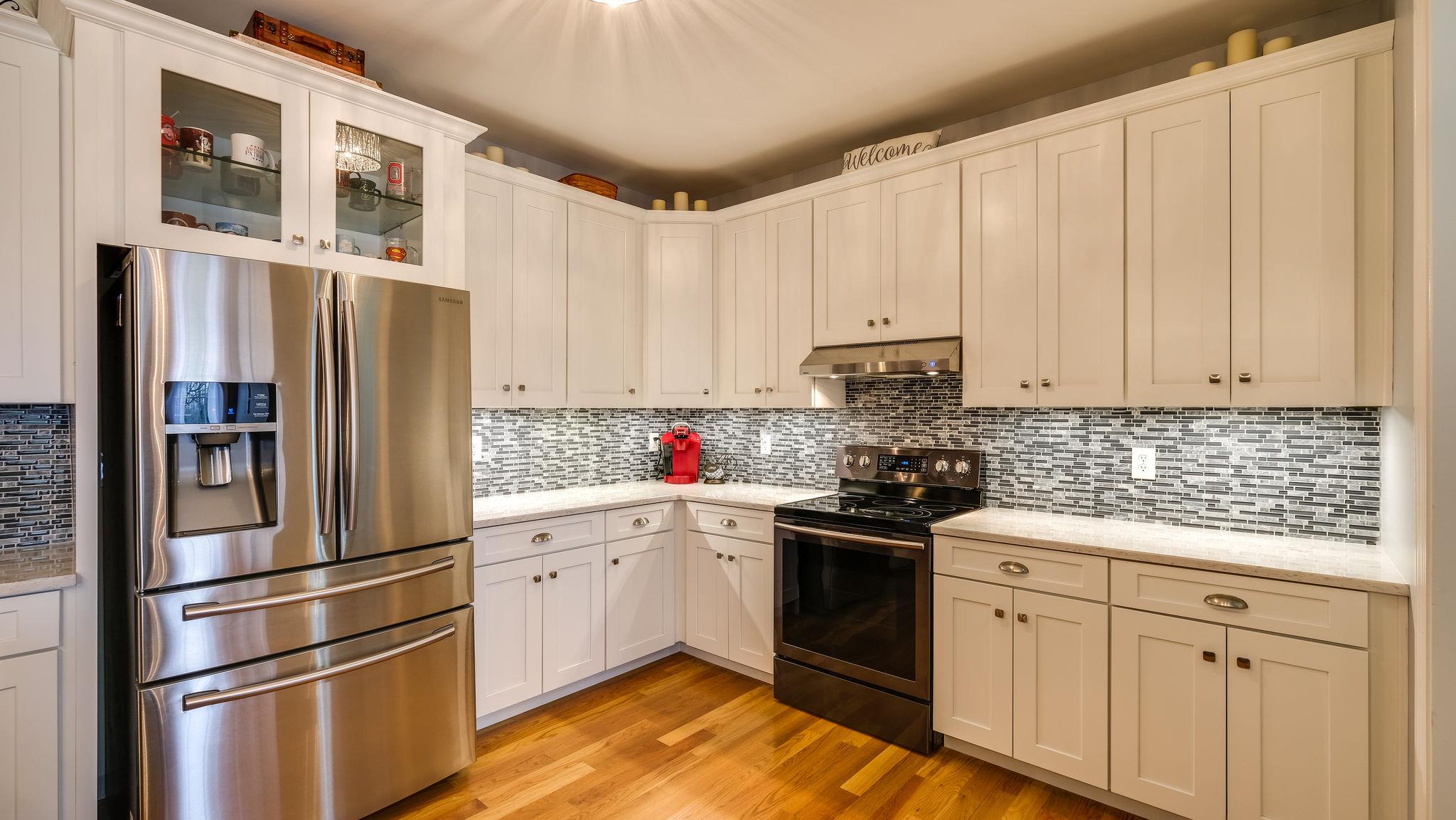 7920 Powells Chapel Road Murfreesboro, TN 37129 - Photo 7 of 29 a kitchen with stainless steel appliances granite countertop a refrigerator sink and white cabinets