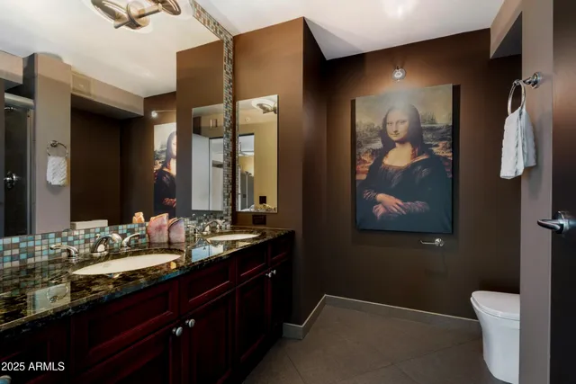 a bathroom with a sink vanity and toilet