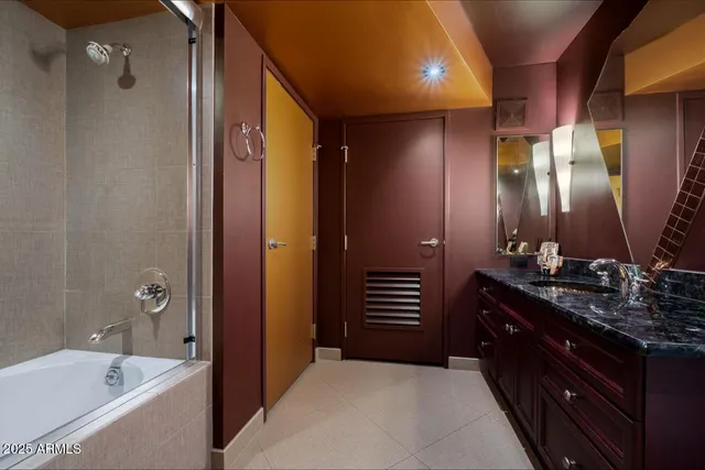 a bathroom with a bathtub a sink and a mirror