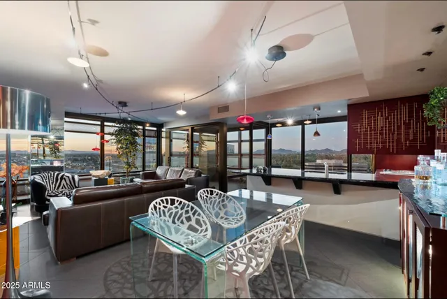 a outdoor space with lots of tables a large window and furniture