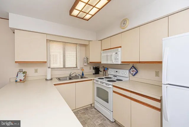 a kitchen with a sink cabinets and window
