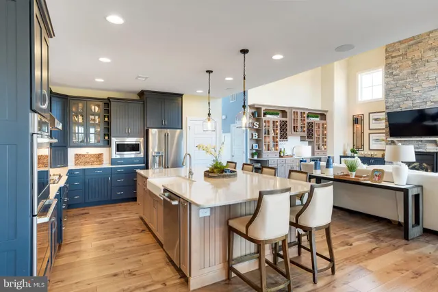 a kitchen with stainless steel appliances kitchen island granite countertop a sink and cabinets