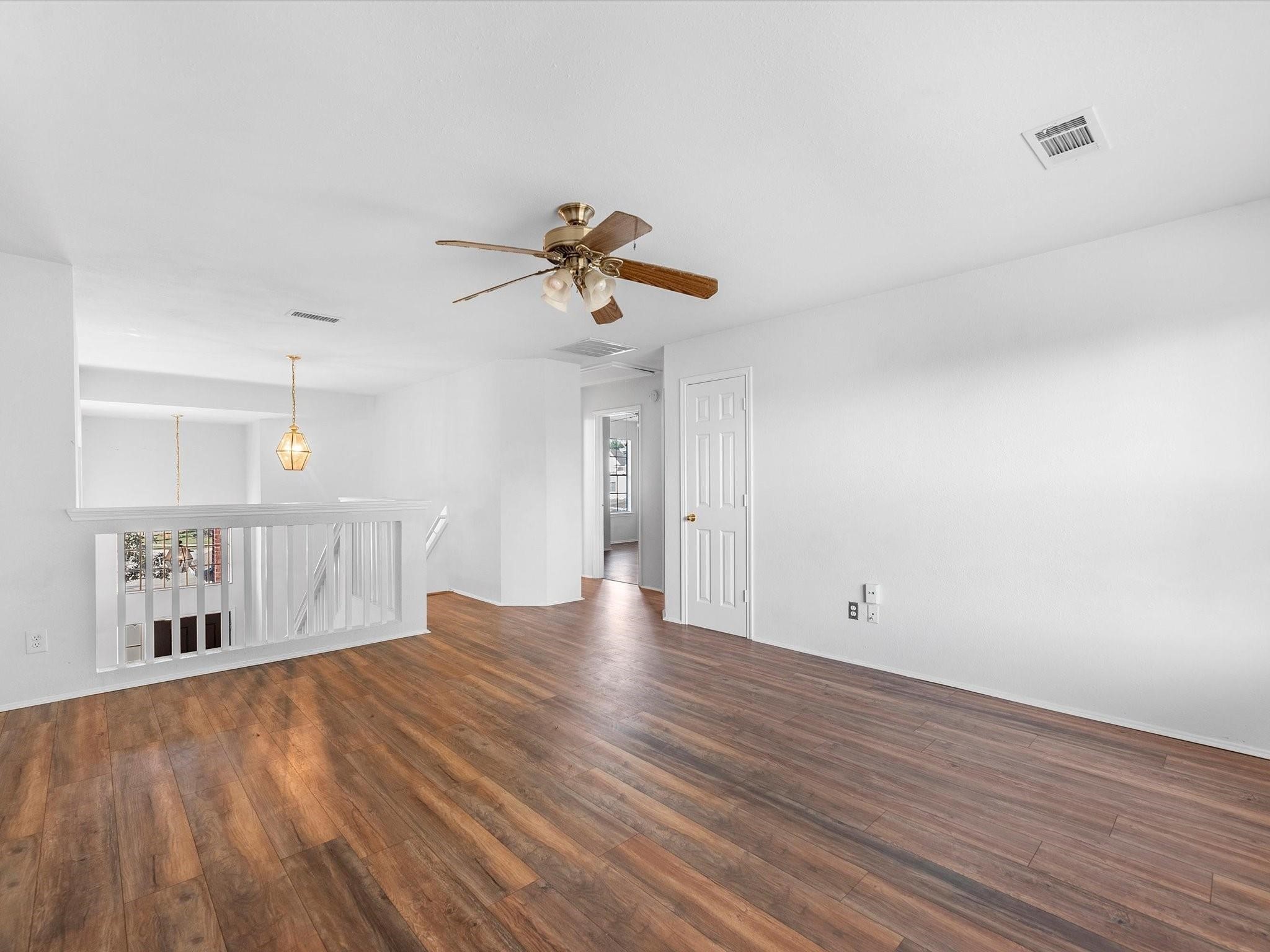 14306 Spring Marsh Court Cypress, TX 77429 - Photo 15 of 26 a view of an empty room with window and wooden floor