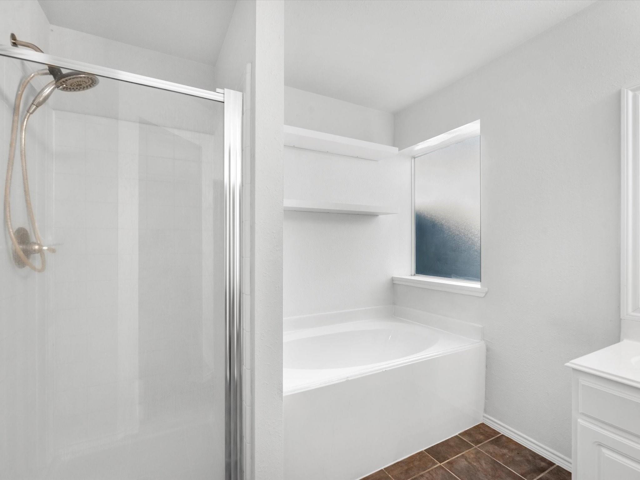 14306 Spring Marsh Court Cypress, TX 77429 - Photo 18 of 26 a bathroom with a bathtub and a shower