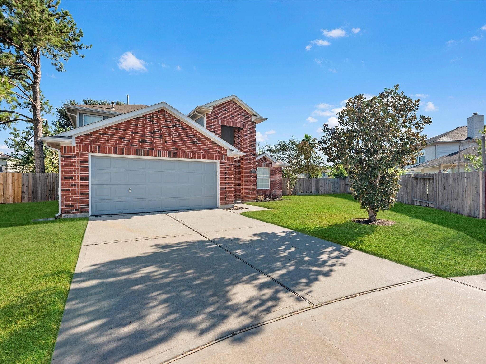14306 Spring Marsh Court Cypress, TX 77429 - Photo 2 of 26 a front view of a house with a yard and garage