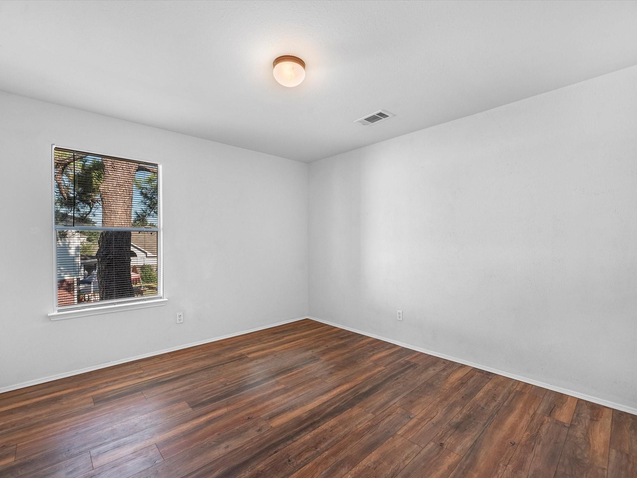 14306 Spring Marsh Court Cypress, TX 77429 - Photo 22 of 26 a view of empty room with wooden floor and fan