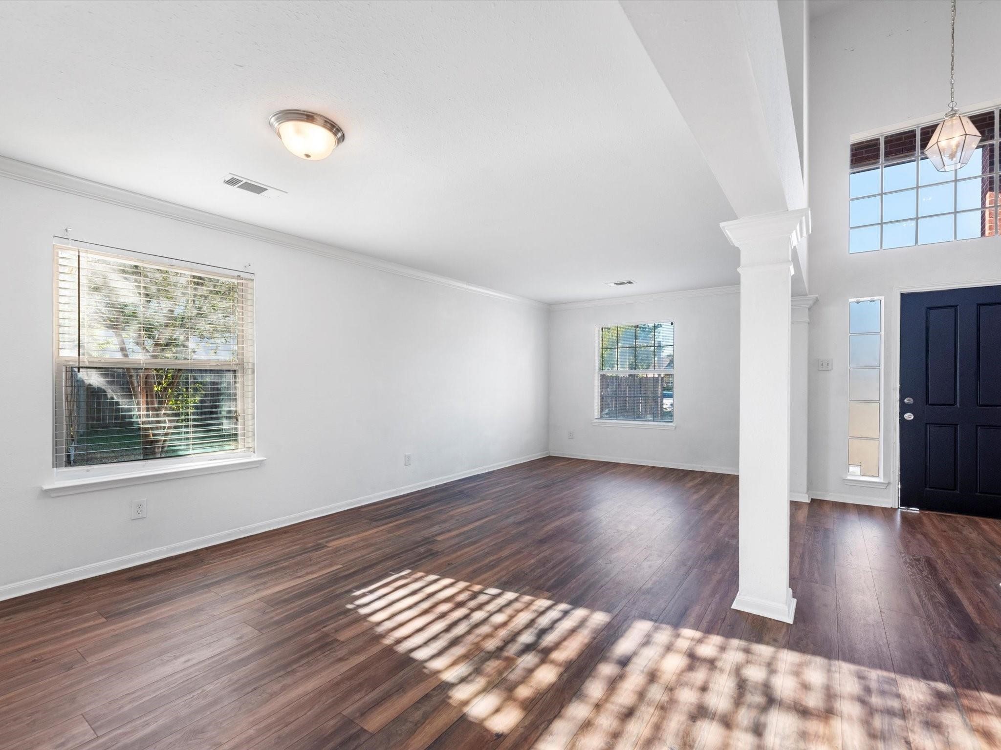 14306 Spring Marsh Court Cypress, TX 77429 - Photo 5 of 26 a view of an empty room with wooden floor and a window