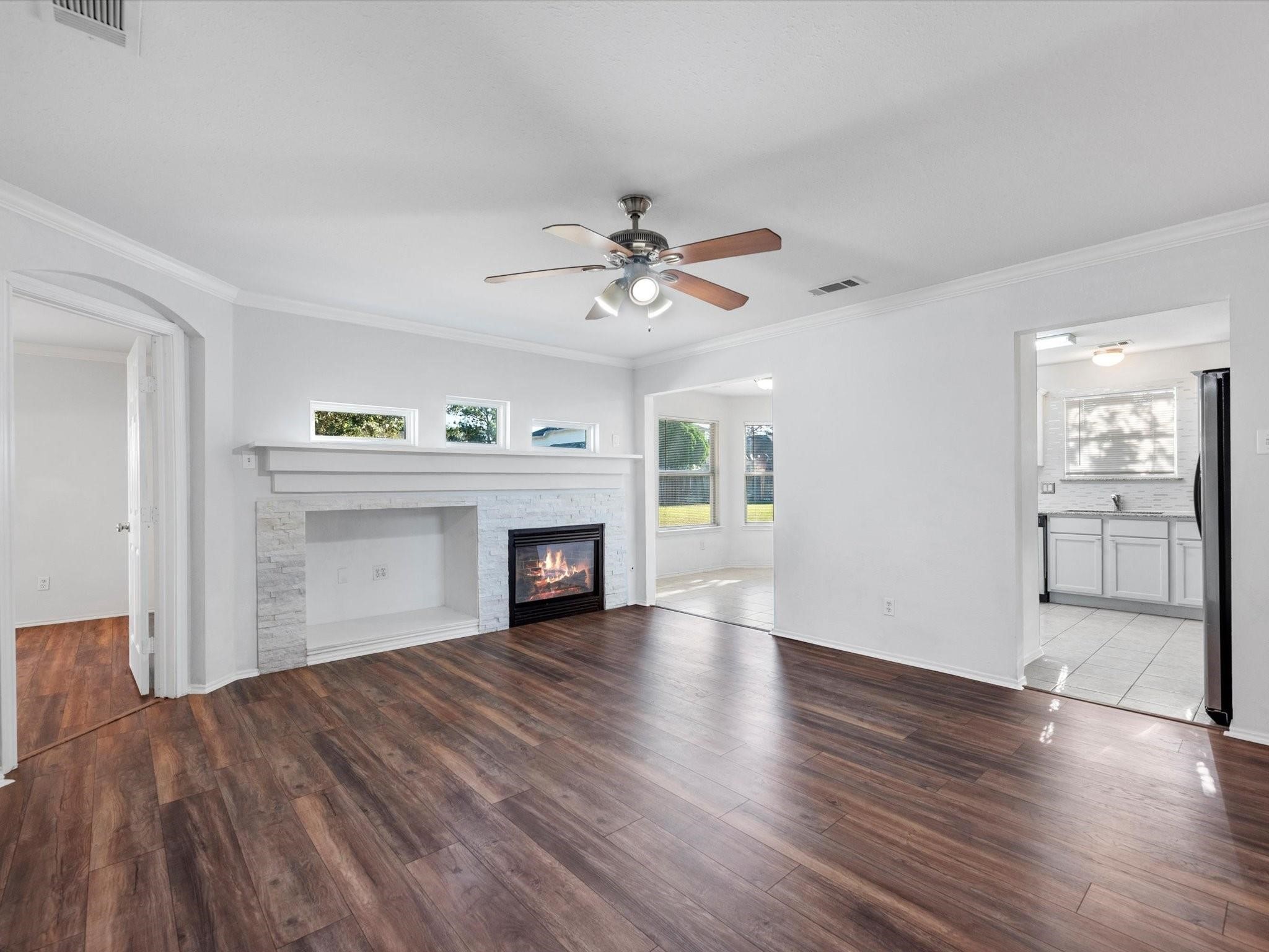 14306 Spring Marsh Court Cypress, TX 77429 - Photo 8 of 26 a view of an empty room with a fireplace and a kitchen