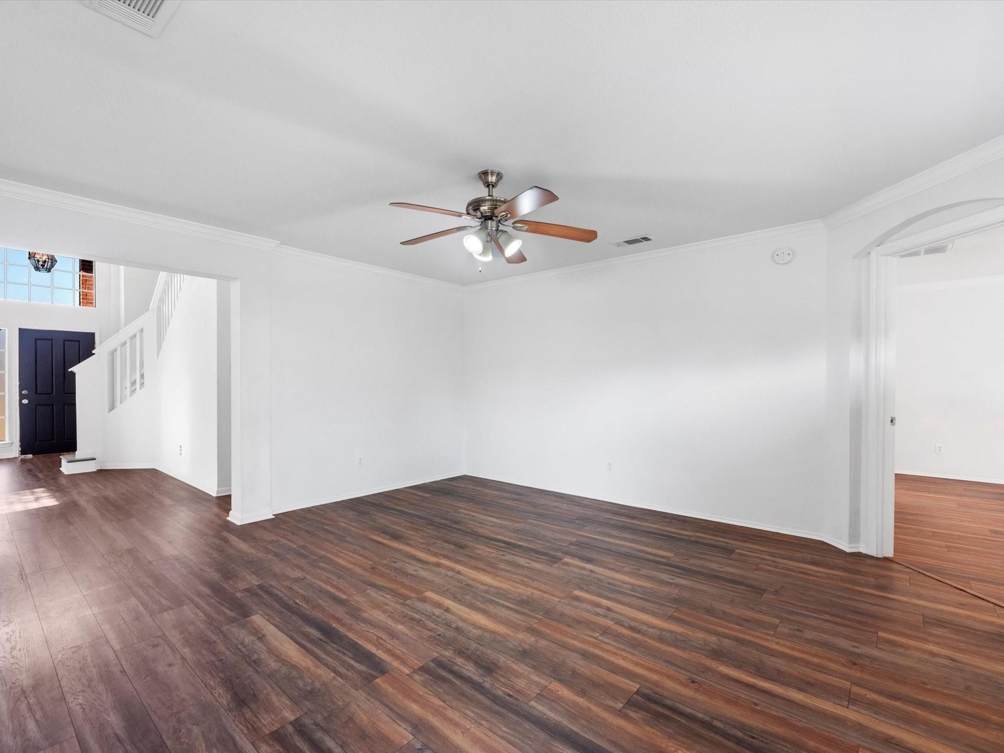 14306 Spring Marsh Court Cypress, TX 77429 - Photo 9 of 26 a view of a room with wooden floor and a ceiling fan