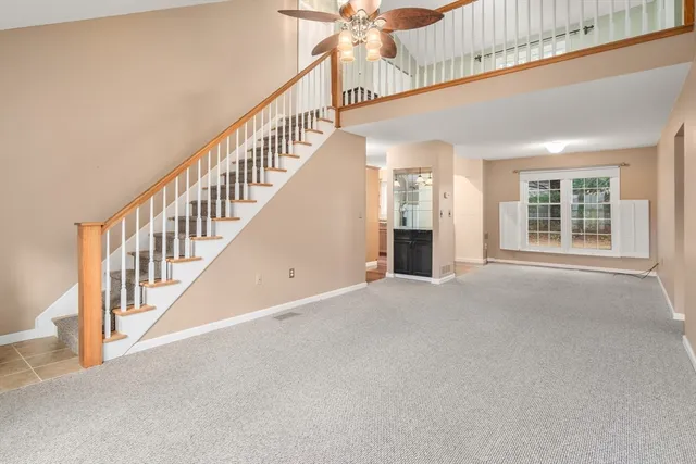 a view of an empty room with a kitchen