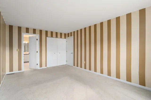 a spacious bathroom with a shower and a mirror