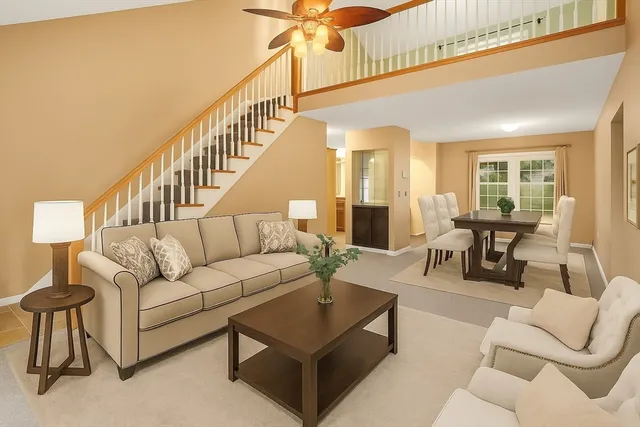 a living room with furniture and a dining table