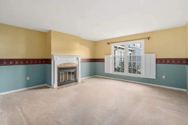 a view of an empty room with wooden floor and a floor to ceiling window