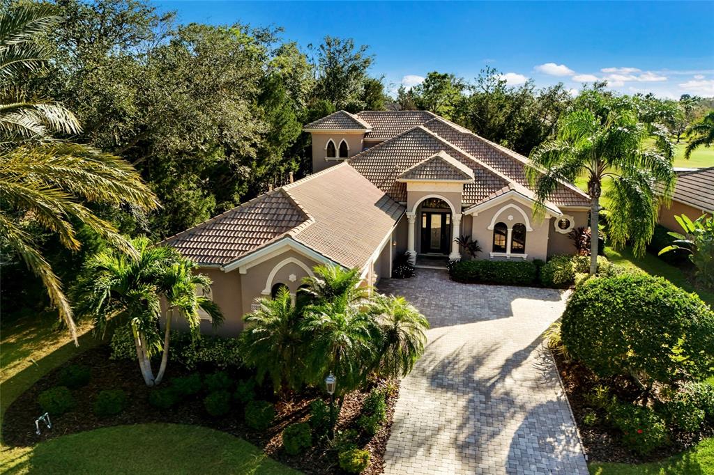 7062 Vilamoura Place Lakewood Ranch, FL 34202 - Photo 1 of 1 a view of a house with a yard and potted plants