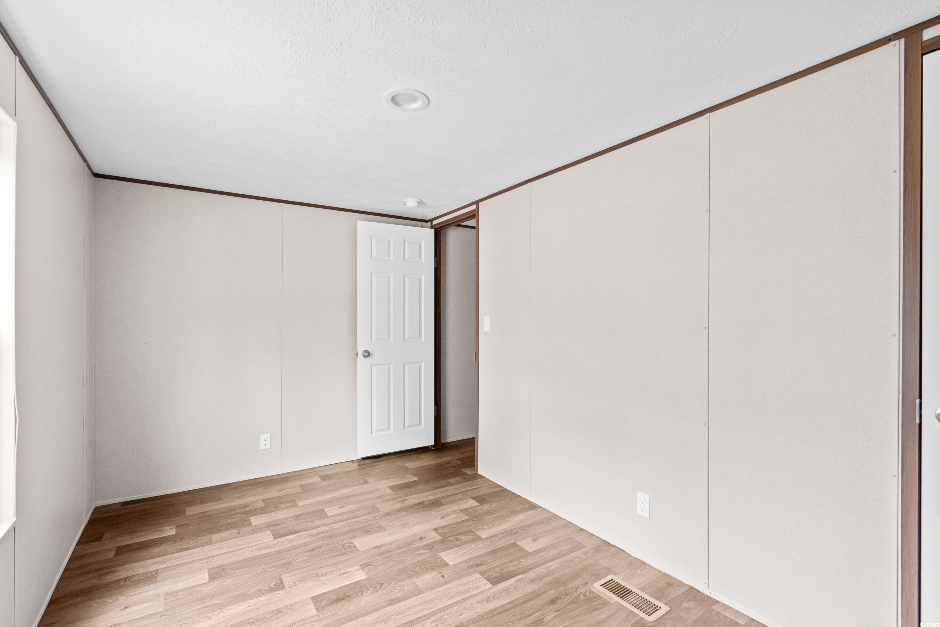 540 Key Largo Avenue Murrells Inlet, SC 29576 - Photo 16 of 34 Unfurnished bedroom featuring light wood-type floo