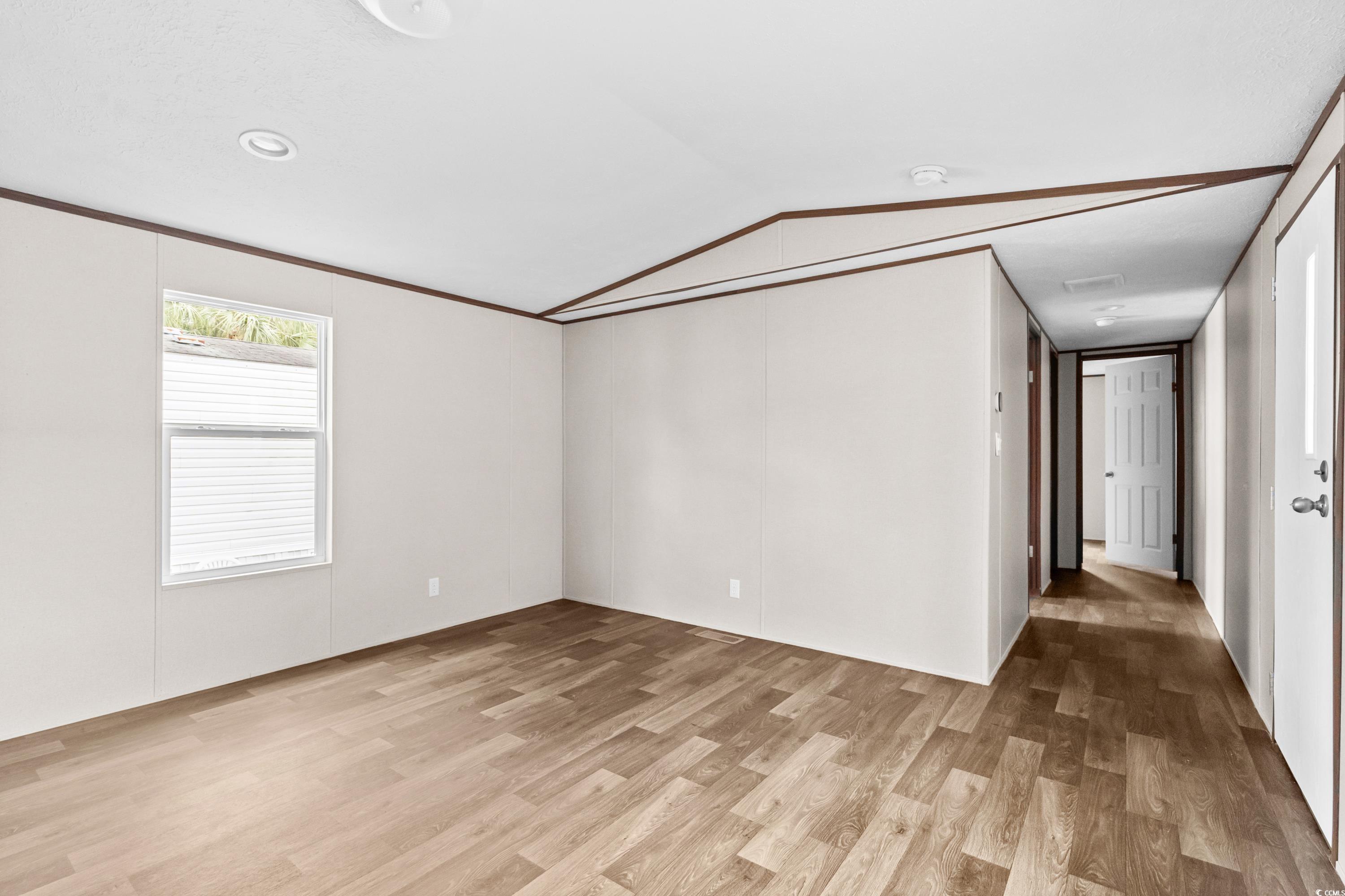 540 Key Largo Avenue Murrells Inlet, SC 29576 - Photo 6 of 34 Unfurnished room featuring vaulted ceiling and lig