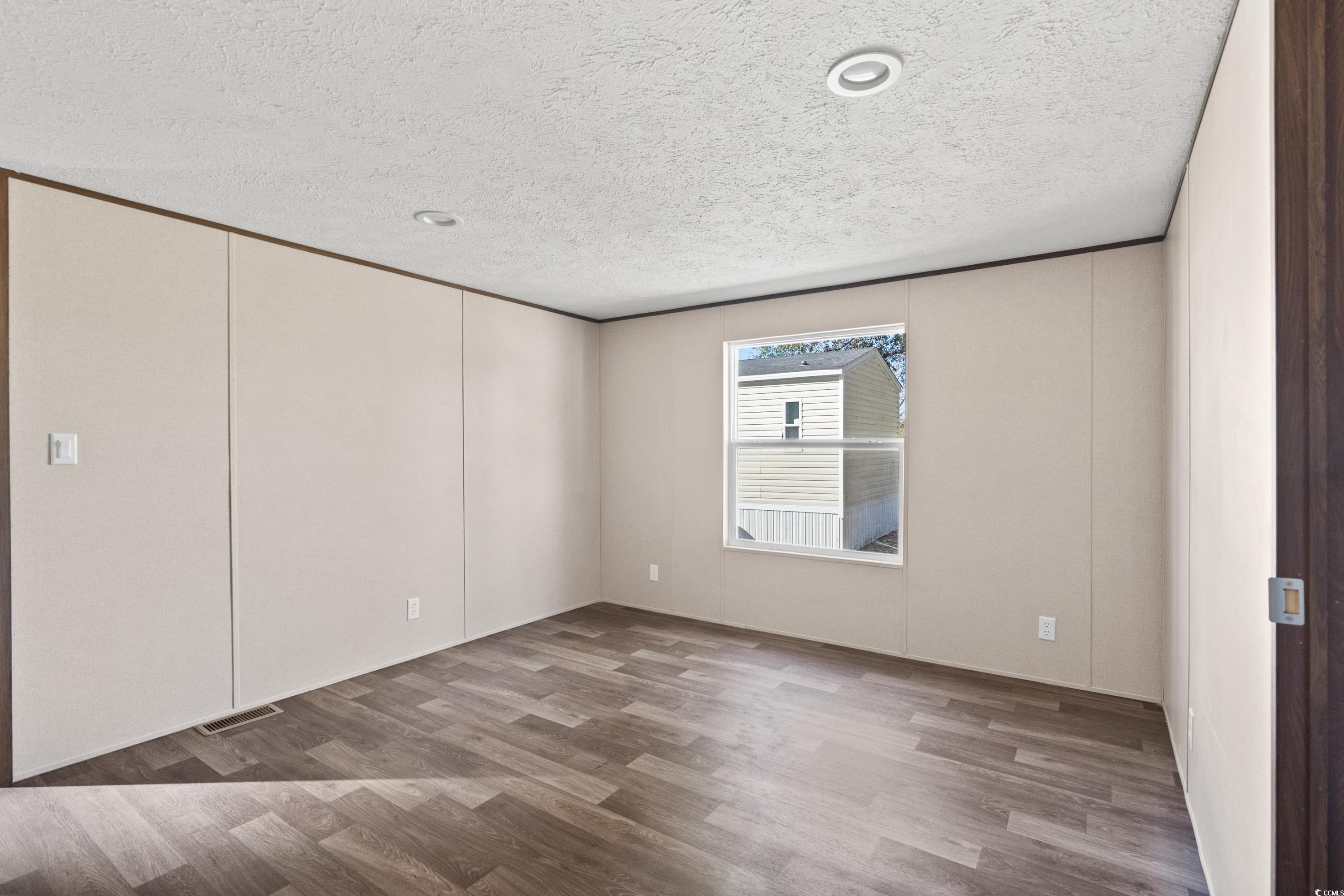 540 Key Largo Avenue Murrells Inlet, SC 29576 - Photo 9 of 34 Empty room with hardwood / wood-style floors and a
